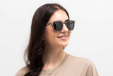 Woman wearing Hunter Brown Sunglasses, retro square wooden sunglasses with grey polarized lens