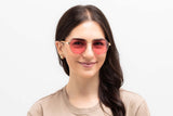 Woman wearing Elton, Elton John Sunglasses in Pink Hexagon