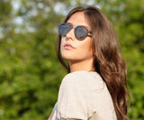 Woman wearing Kraywoods Ash, Rounded Aviator Wood Sunglasses with grey polarized lenses