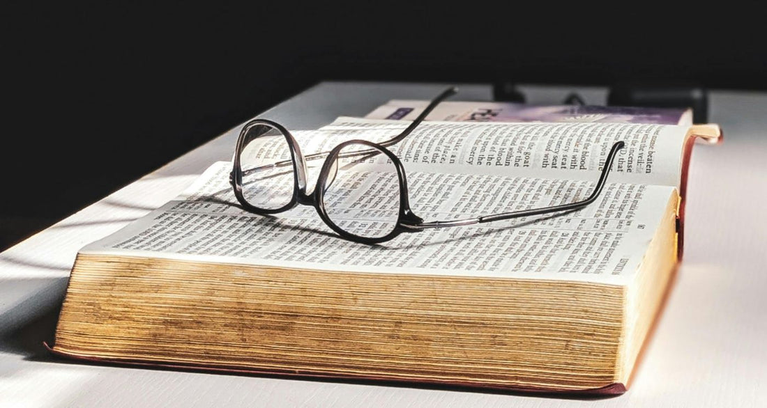 glasses on an open chunky old book