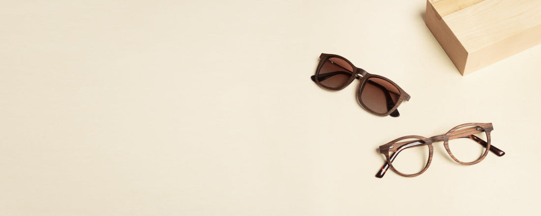 flat lay image of Kraywoods sunglasses and light-adaptive glasses on neutral background
