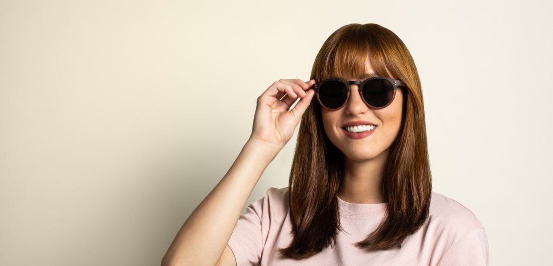Woman with oblong face wearing round sunglasses
