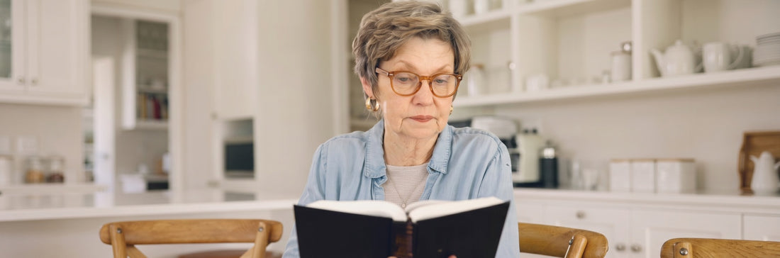 woman reading Kraywoods reading glasses while reading her book