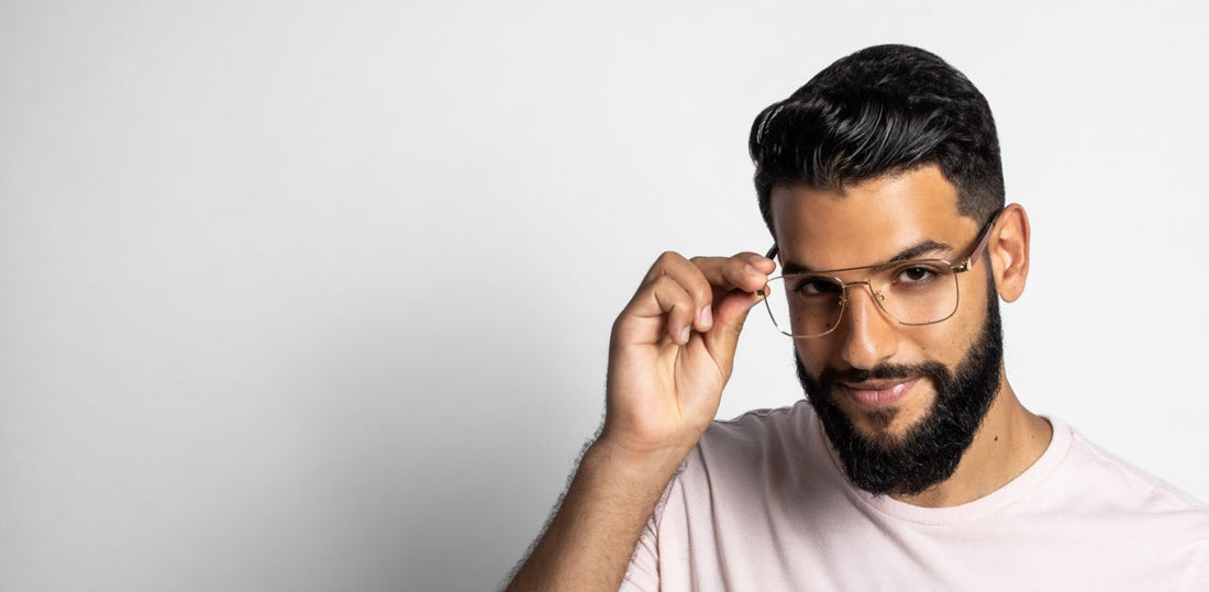 man wearing Drive Gold minimalistic eyeglasses on a white background