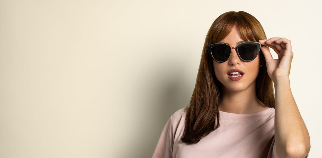 woman wearing Willow oversized cat-eye sunglasses on a light pink background 