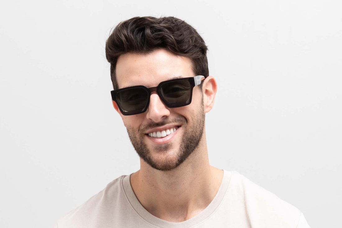 Man wearing Noir Sunglasses, Oversized black square sunglasses with green polarized lens